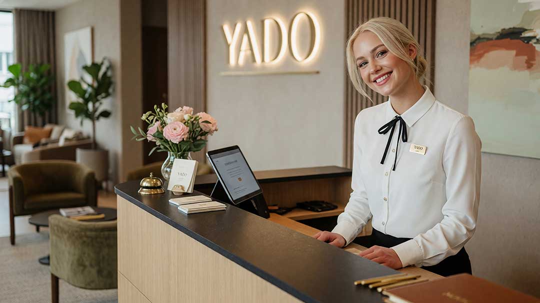 A receptionist behind a desk at the Yado Hotel